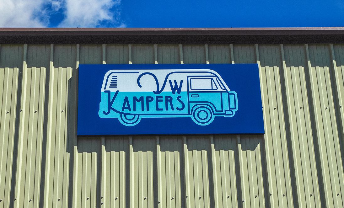 The outside of a camper van showroom showcasing the new branding