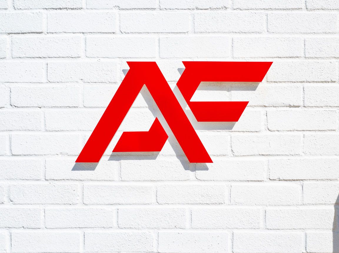 A red A F sign on a white brick wall