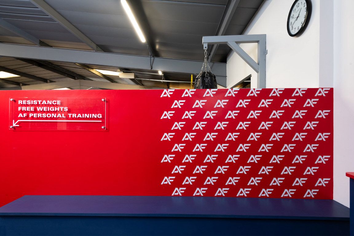 A low red wall with a repeating pattern using the brands A and F